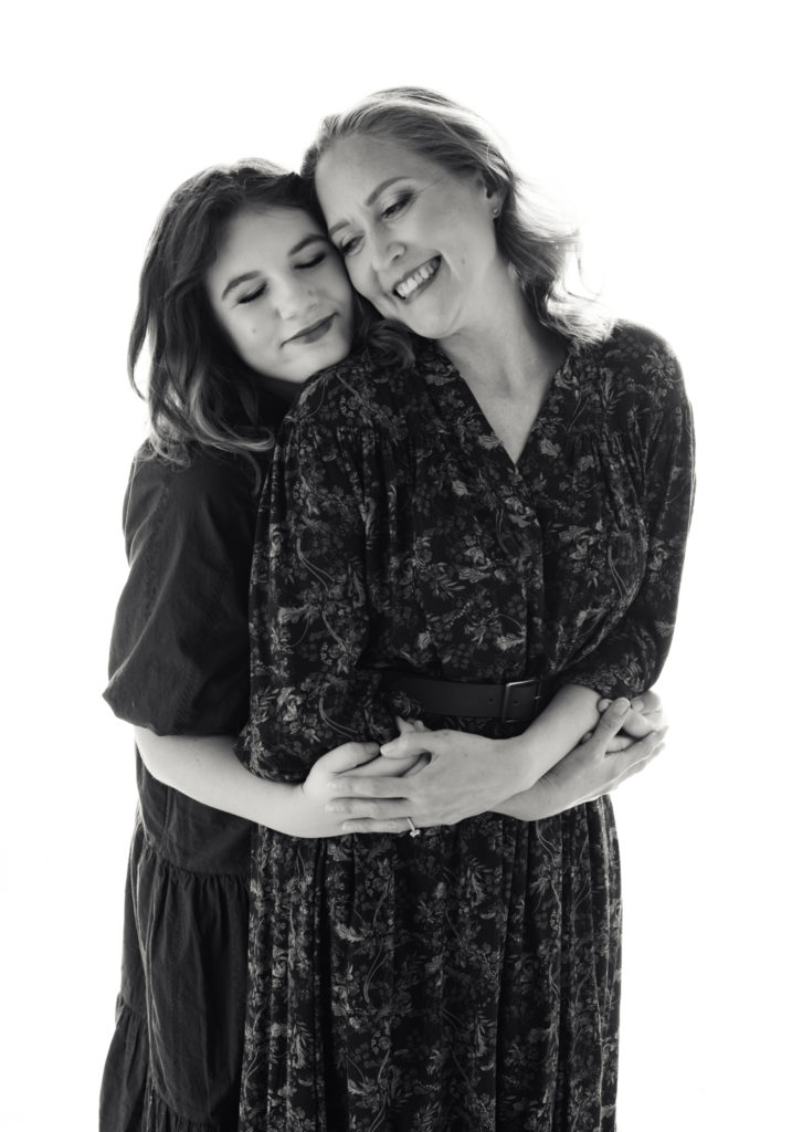 A mother and daughter together looking beautiful in black and white