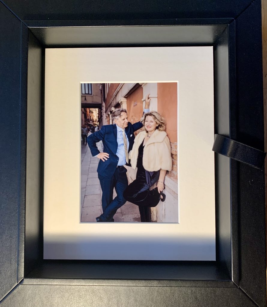 Matted photographs in a folio box of a couple in Venice