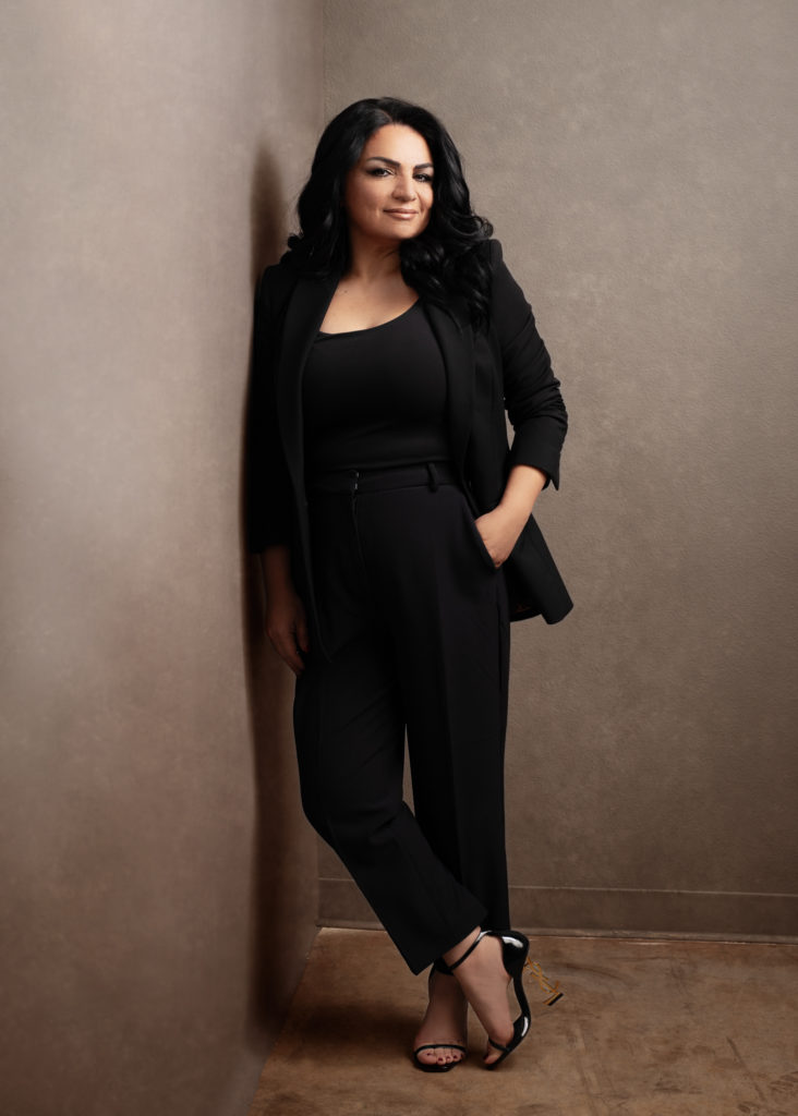 Lux branding portrait headshot photo of a woman wearing a black suit and designer shoes