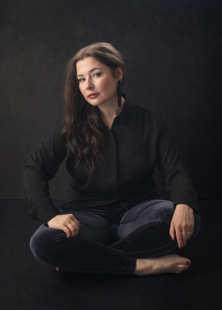 painterly photo of a brunette sitting on the floor with velvet leggings for her body image journey photoshoot