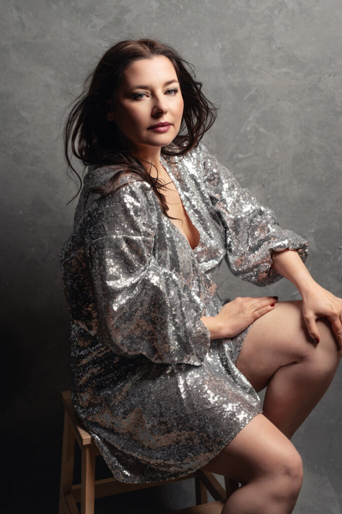 Woman with a silver sequin dress for her body image journey photoshoot