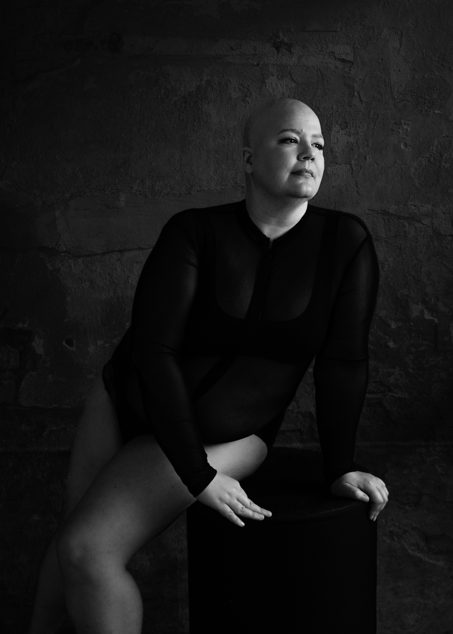 black and white photo of a woman with no hair after chemo